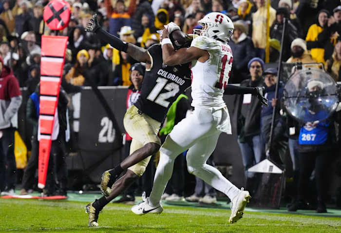 Oct 13, 2023; Boulder, Colorado, USA; Stanford Cardinal wide receiver Elic Ayomanor (13) pulls in a touchdown behind the pack of Colorado Buffaloes cornerback Travis Hunter (12) in overtime at Folsom Field. Mandatory Credit: Ron Chenoy-USA TODAY Sports